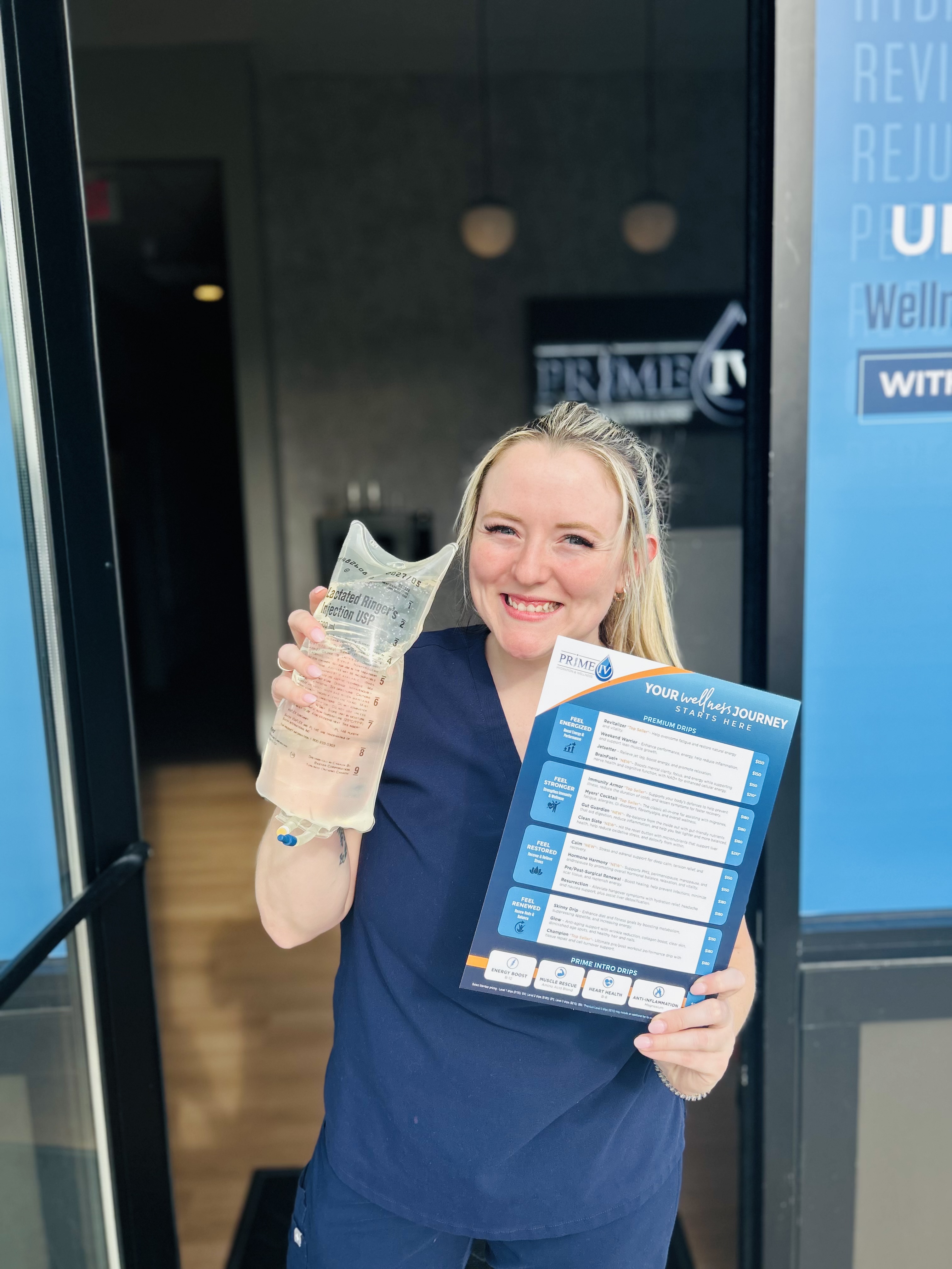 Smiling team member holding the wellness menu at the Prime IV Nolensville entrance