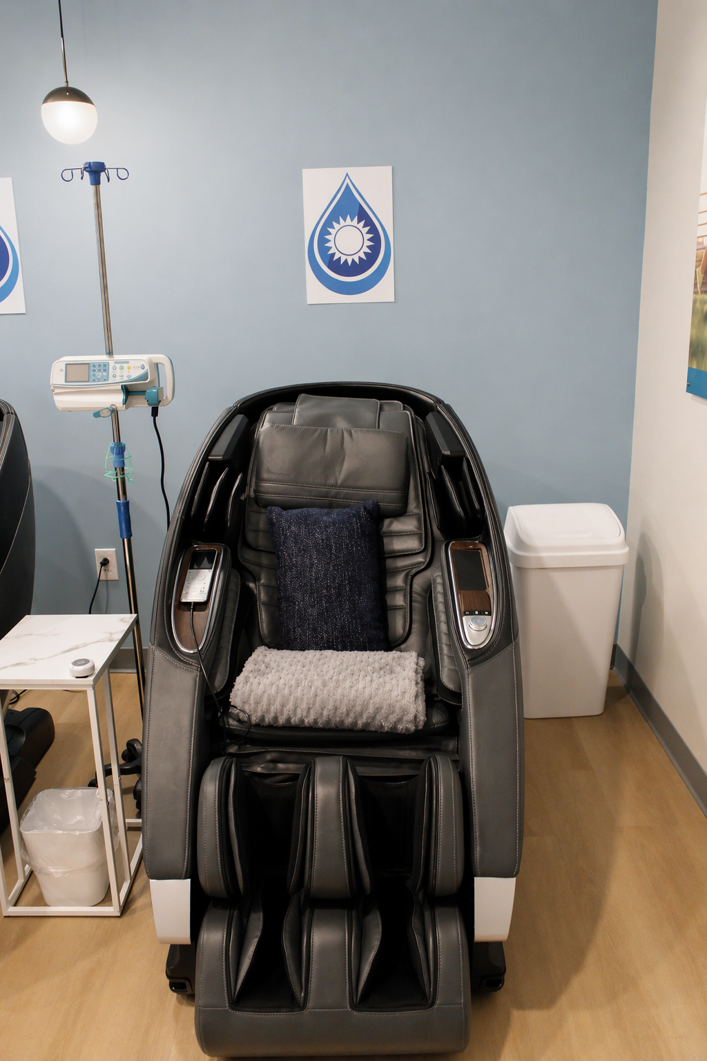 Private treatment room with a zero-gravity massage chair and IV stand